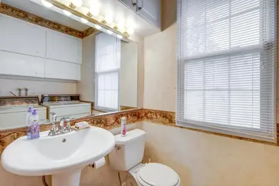 a bathroom with a white sink and a toilet at Spacious Studio - 5 Mi to MGM Northfield Park! in Maple Heights