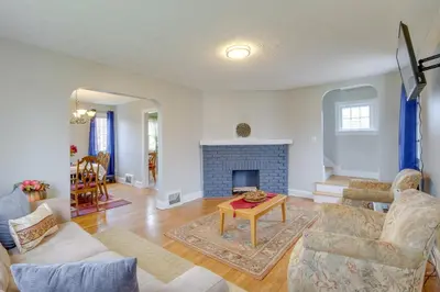 a living room with a couch and a fireplace at Inviting Vacation Home 2 Mi to Mill Creek Falls! in Garfield Heights