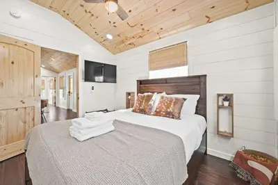 a bedroom with a large bed and a television at Lodge 101 at Eden Reserve Near Ark in Williamstown