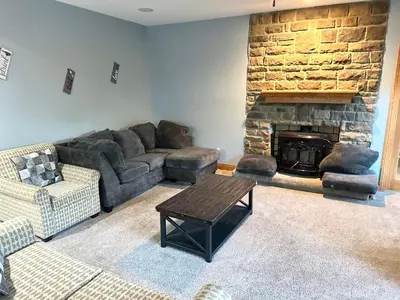 a living room with a couch and a fireplace at Nice Home in Hudson in Hudson