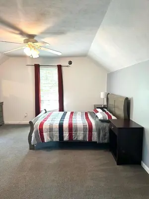 a bedroom with a bed and a ceiling fan at Nice Home in Hudson in Hudson