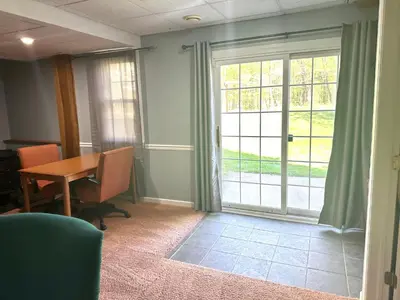 a room with a table and a door with a window at Nice Home in Hudson in Hudson