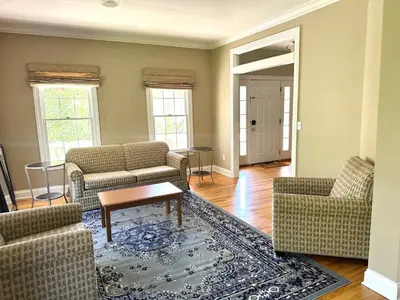 a living room with two couches and a table at Nice Home in Hudson in Hudson