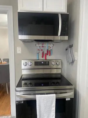 a kitchen with a stove and a microwave at Home in Anderson Township in Cincinnati