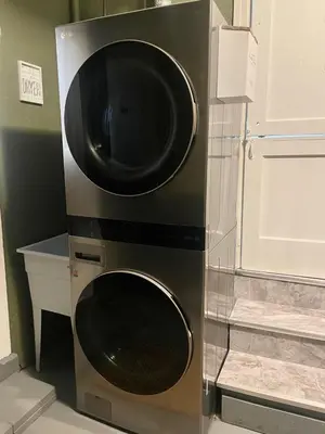 a microwave and a washer and dryer in a room at Home in Anderson Township in Cincinnati