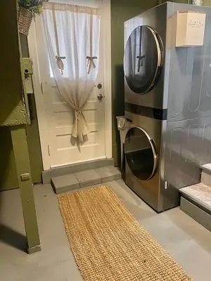 a kitchen with a washing machine next to a door at Home in Anderson Township in Cincinnati