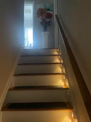 a staircase with a vase with a flower in a window at Home in Anderson Township in Cincinnati