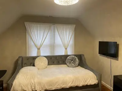a bed with two pillows on it in front of a window at Home in Anderson Township in Cincinnati
