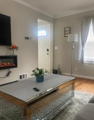 a living room with a glass table and a fireplace at Home in Anderson Township in Cincinnati