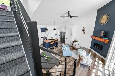 an open living room with a staircase and a living room at Lakeside, Water-view, 7 miles to Ark, 4BR for 14 in Williamstown