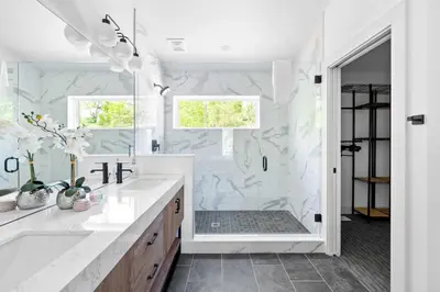 a white bathroom with a shower and a sink at Lakeside, Water-view, 7 miles to Ark, 4BR for 14 in Williamstown