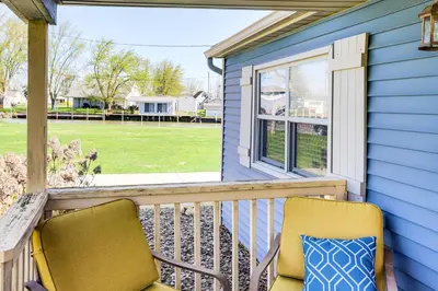 a porch with two chairs and a window at Waterfront Port Clinton Cottage with Fire Pit! in Port Clinton