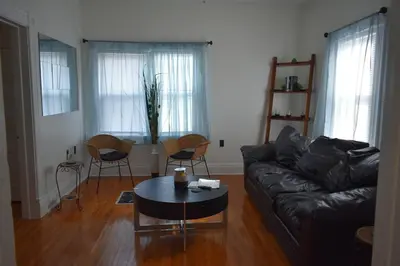a living room with a couch and a table and chairs at Downtown Lima 1 Bdrm Haven! in Lima