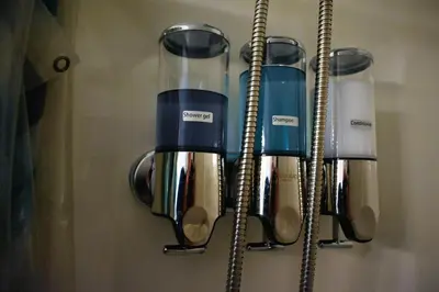 a kitchen utensil rack with four cups and spoons at Downtown Lima 1 Bdrm Haven! in Lima