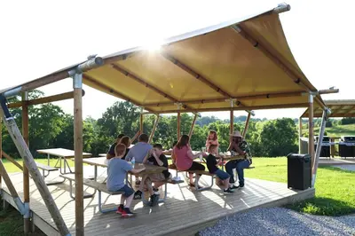a group of people sitting in a gazebo at Block of 7 Lodges at Eden Reserve - For Groups in Williamstown