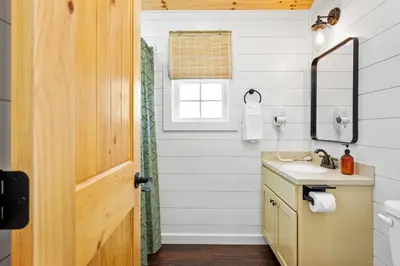 a bathroom with a sink and a mirror at Block of 5 Lodges at Eden Reserve - For Groups in Williamstown