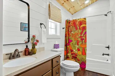 a bathroom with a sink and a shower at The Lodges at Eden Reserve - Cabins Near Ark in Williamstown
