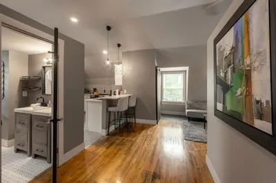 a kitchen and living room with a sink and a counter at Close to Stadiums, Downtown Cincy, & more, 1BR Apt in Ludlow