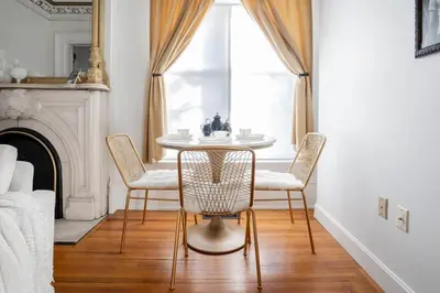 a dining room with a table and chairs and a window at Walk to Stadiums & Downtown, Jet Tub, Historic Apt in Covington
