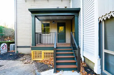 a house with a staircase leading to a door at Walk to Stadiums & Downtown, Jet Tub, Historic Apt in Covington