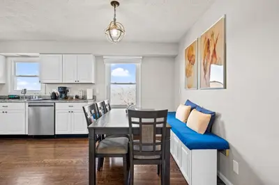 a kitchen and dining room with a table and chairs at 6 Min to Ark, Free Covered Parking, Deck and Grill in Williamstown