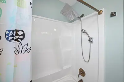 a shower in a bathroom with a shower curtain at 6 Min to Ark, Free Covered Parking, Deck and Grill in Williamstown