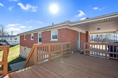 a home with a deck and a house at 6 Min to Ark, Free Covered Parking, Deck and Grill in Williamstown