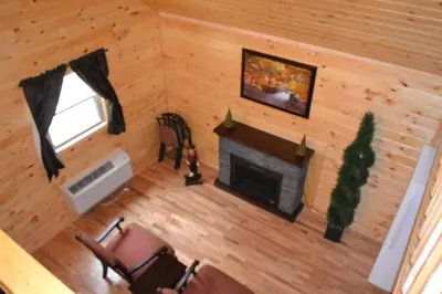 an overhead view of a living room with a fireplace at Blue Rose Cabins - Naughty Pine Cabin in Logan