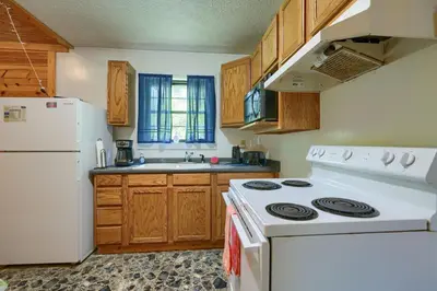 a kitchen with a white stove and a white refrigerator at Blue Rose Cabins - Pinecrest Cabin in Logan