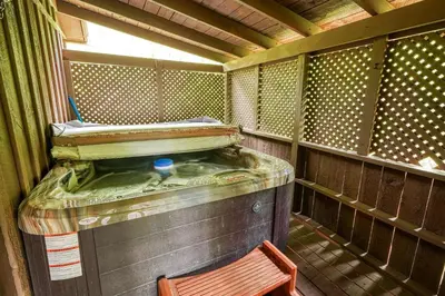 a small room with a bed and a chair in it at Blue Rose Cabins - Pinecrest Cabin in Logan