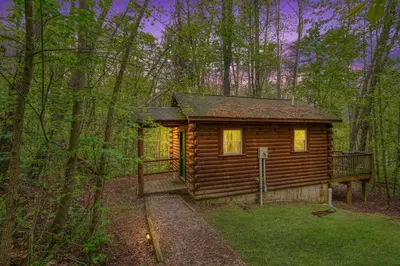 a log cabin in the middle of the woods at Blue Rose Cabins - Sweet Dreams Cabin in Logan