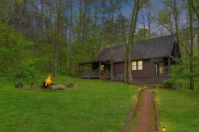 a house with a fire hydrant in front of it at Blue Rose Cabins - Rosewood Cabin in Logan