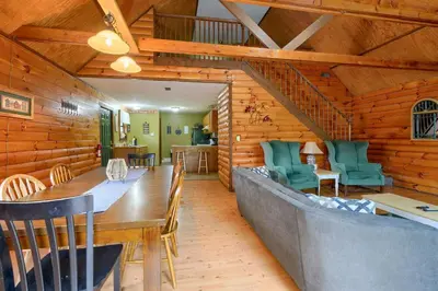 a dining room with a long table and chairs at Blue Rose Cabins - Rosewood Cabin in Logan