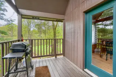 a screened in porch with a grill on it at Blue Rose Cabins - Rosewood Cabin in Logan