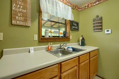 a kitchen with a sink and a window at Blue Rose Cabins - Rosewood Cabin in Logan