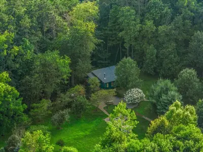 an aerial view of a house in the woods at Beautiful Tiny House, Sauna, Mohican Getaway in Perrysville