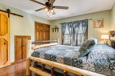 a bedroom with a bed and a ceiling fan at Family-Friendly Milton Home on 14 Acres with Hot Tub in Milton