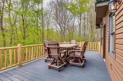 a wooden deck with a table and chairs on it at Family-Friendly Milton Home on 14 Acres with Hot Tub in Milton