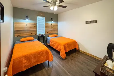 a bedroom with two beds and a ceiling fan at White Oak Cabin in Argillite