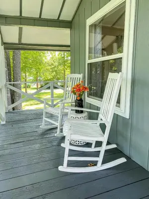 two white rocking chairs sitting on a porch at White Oak Cabin in Argillite