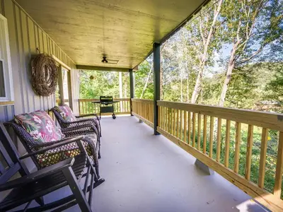 a porch with two chairs and a table at Hickory House Cabin in Ashley