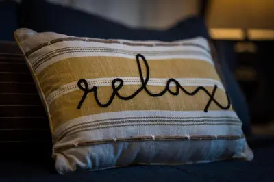 a pillow with the word welcome written on it at Hickory House Cabin in Ashley