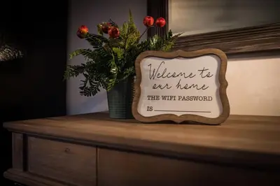a sign on a dresser with a vase of flowers at Hickory House Cabin in Ashley