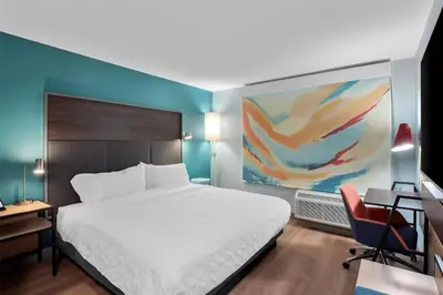 a bedroom with a bed and a desk and a chair at Tru By Hilton Wauseon in Wauseon