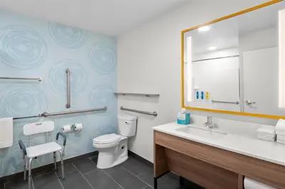 a bathroom with a toilet and a sink and a mirror at Tru By Hilton Wauseon in Wauseon