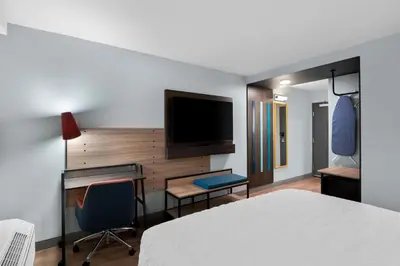 a hotel room with a bed and a desk and a tv at Tru By Hilton Wauseon in Wauseon