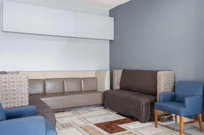 a waiting room with a couch and two chairs at Super 8 by Wyndham Fort Wayne in Fort Wayne