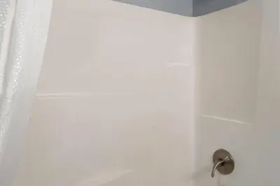 a bathroom with a shower with a shower curtain at Super 8 by Wyndham Fort Wayne in Fort Wayne