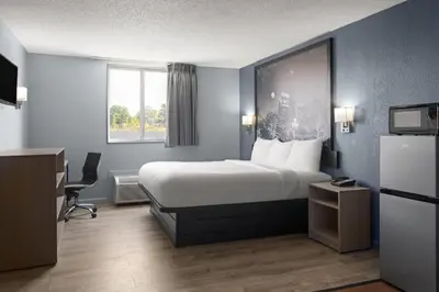 a hotel room with a bed and a window at Super 8 by Wyndham Fort Wayne in Fort Wayne