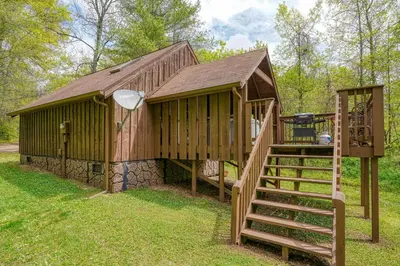 a large wooden building with a staircase in front of it at Blue Rose Cabins - Country Cottage in Logan